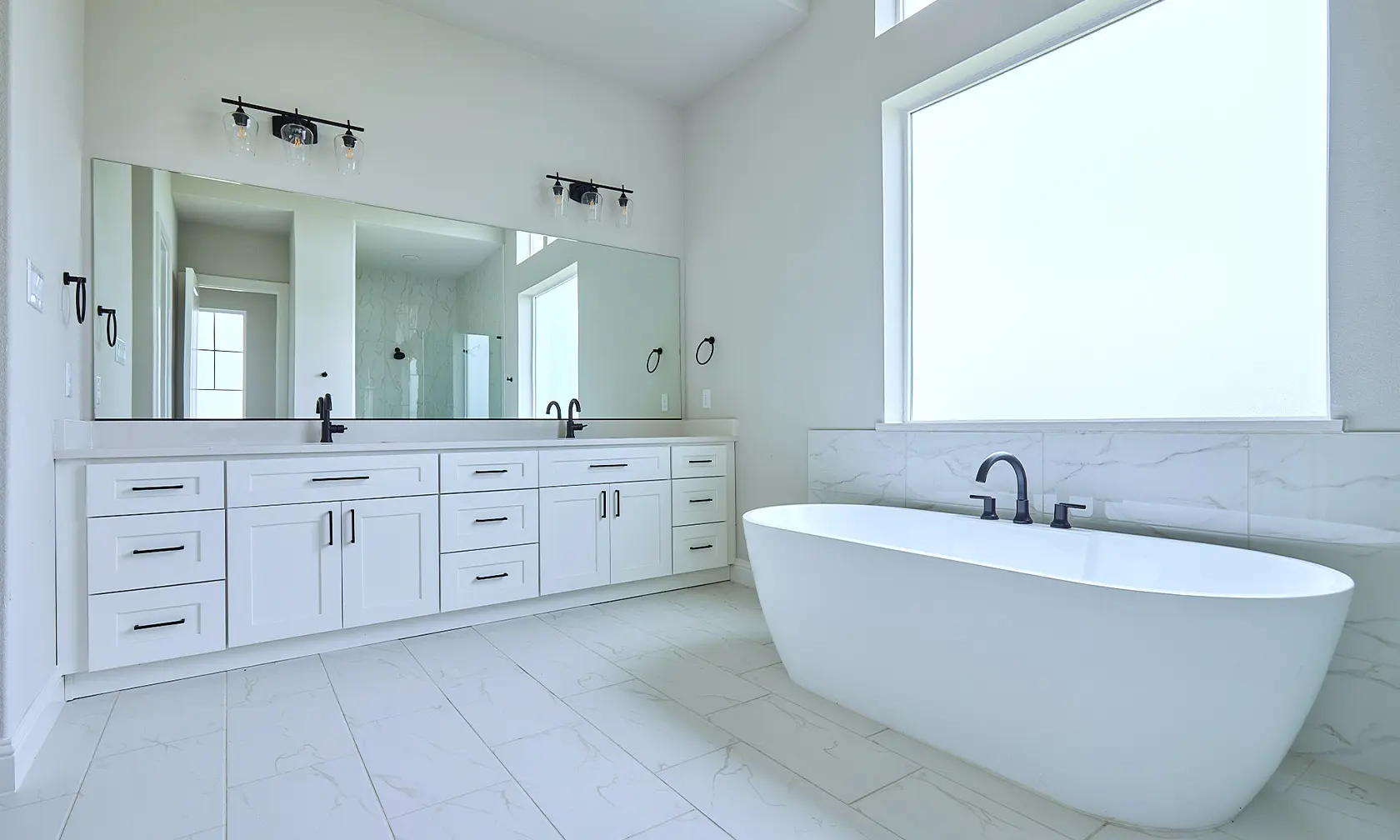 A bathroom with white tile floors and walls.