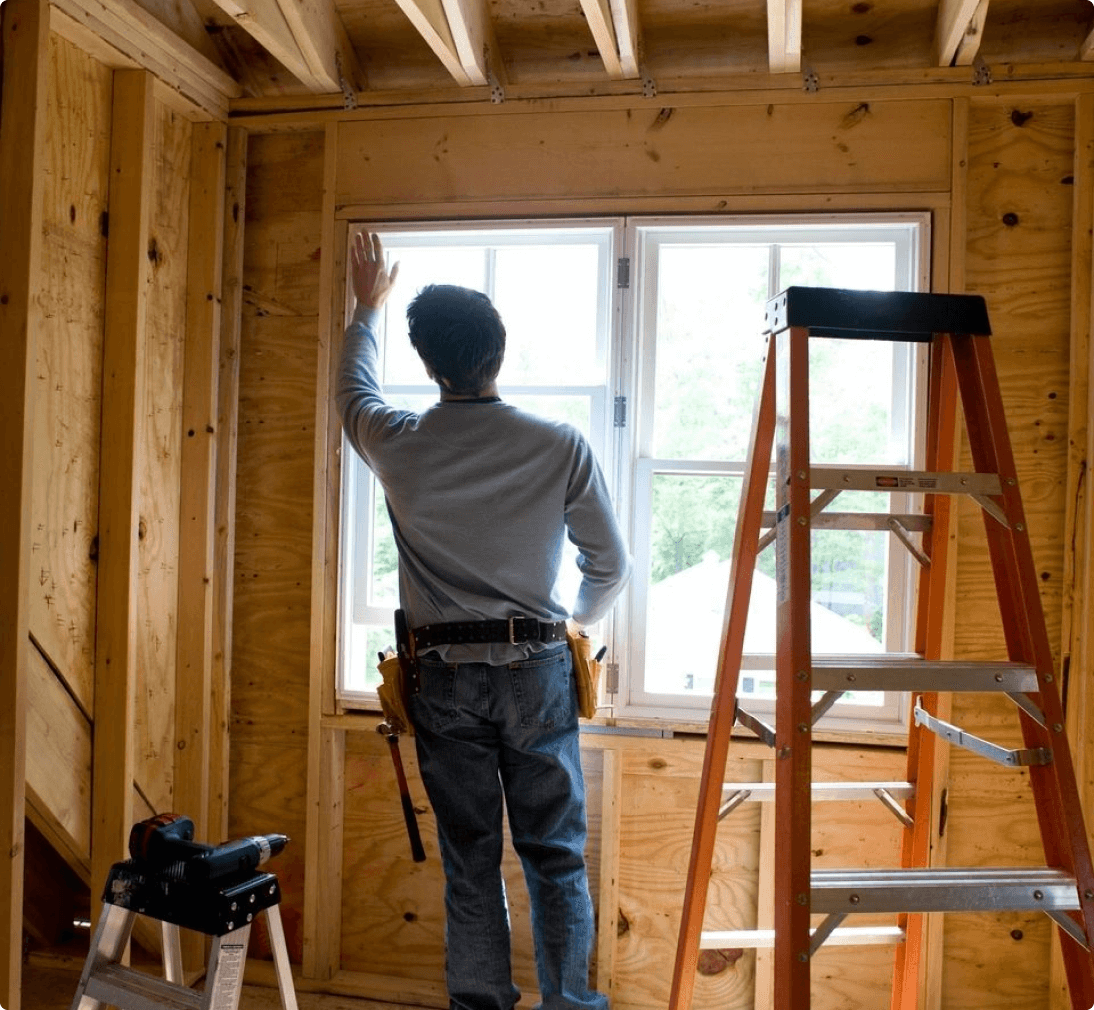 A man standing in front of a window.