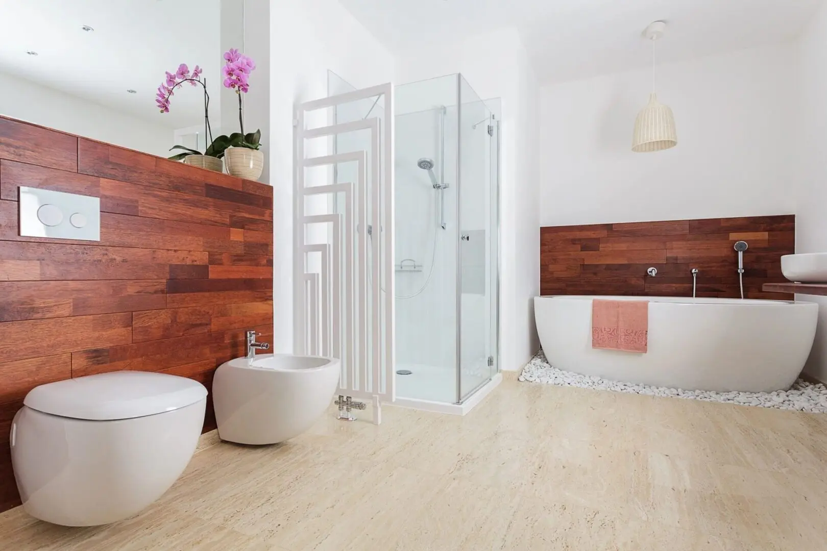 A bathroom with wood floors and white walls.