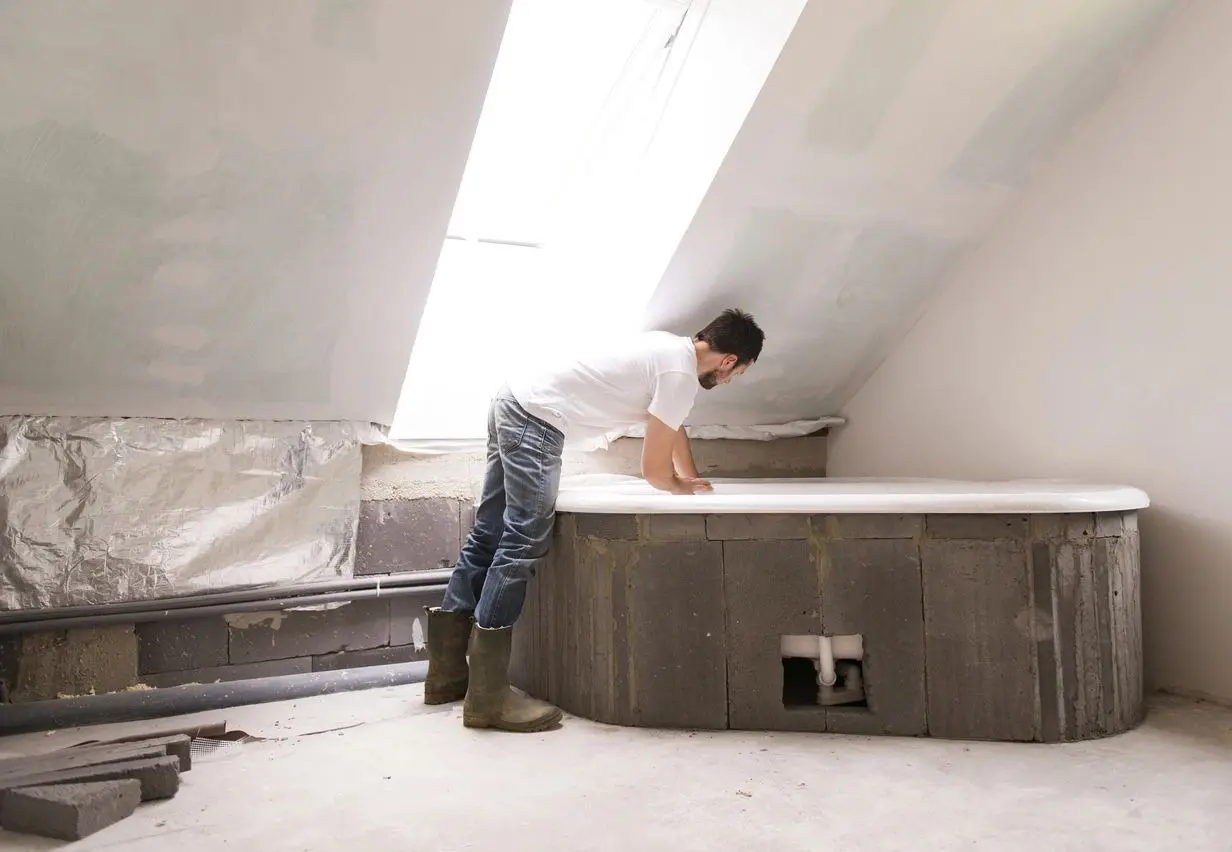 A man in white shirt and brown boots standing on top of floor.