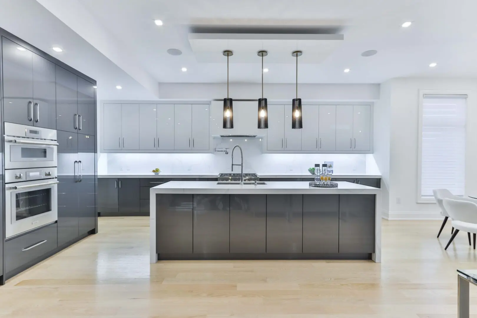 A kitchen with white walls and wooden floors.