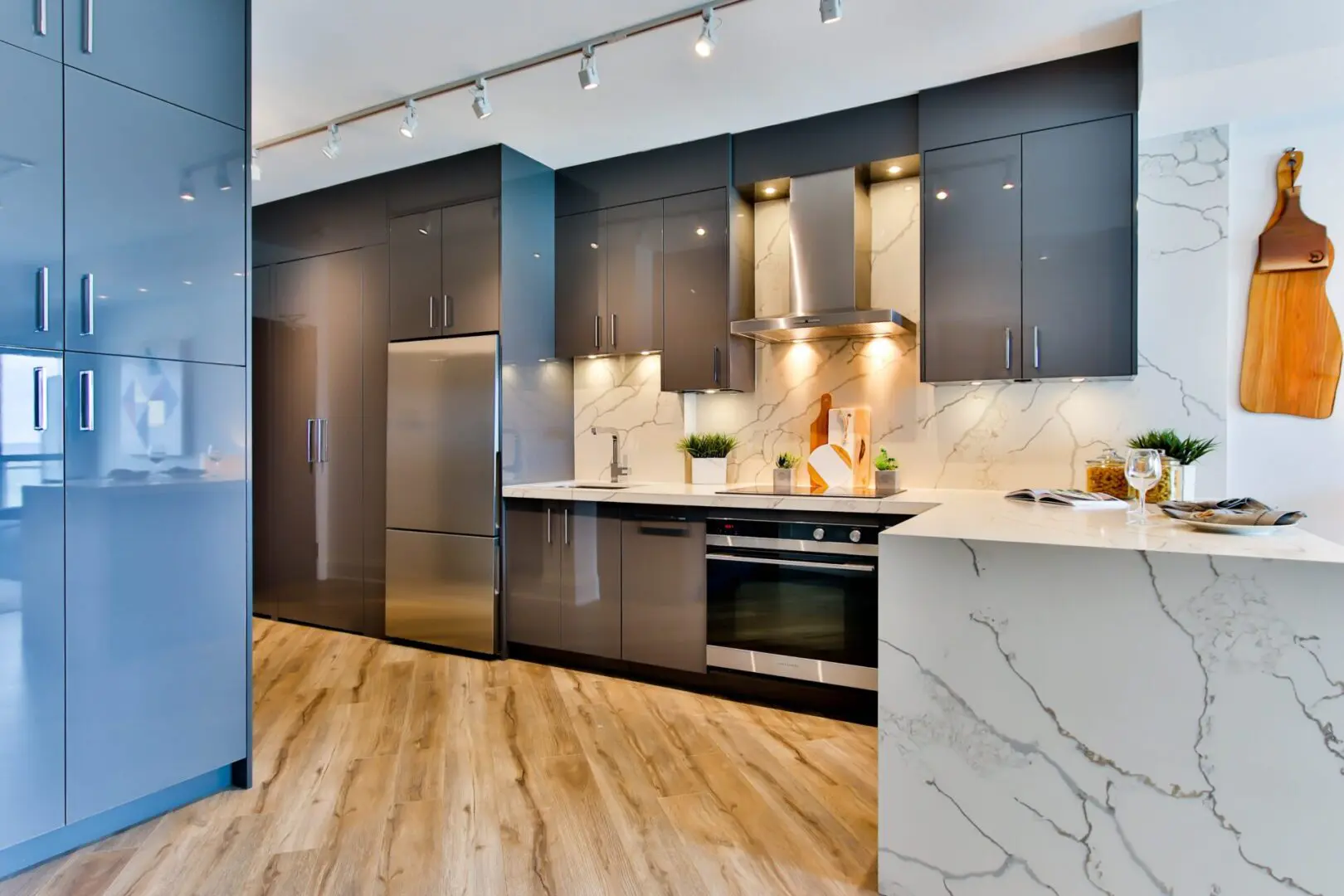 A kitchen with stainless steel appliances and marble counters.